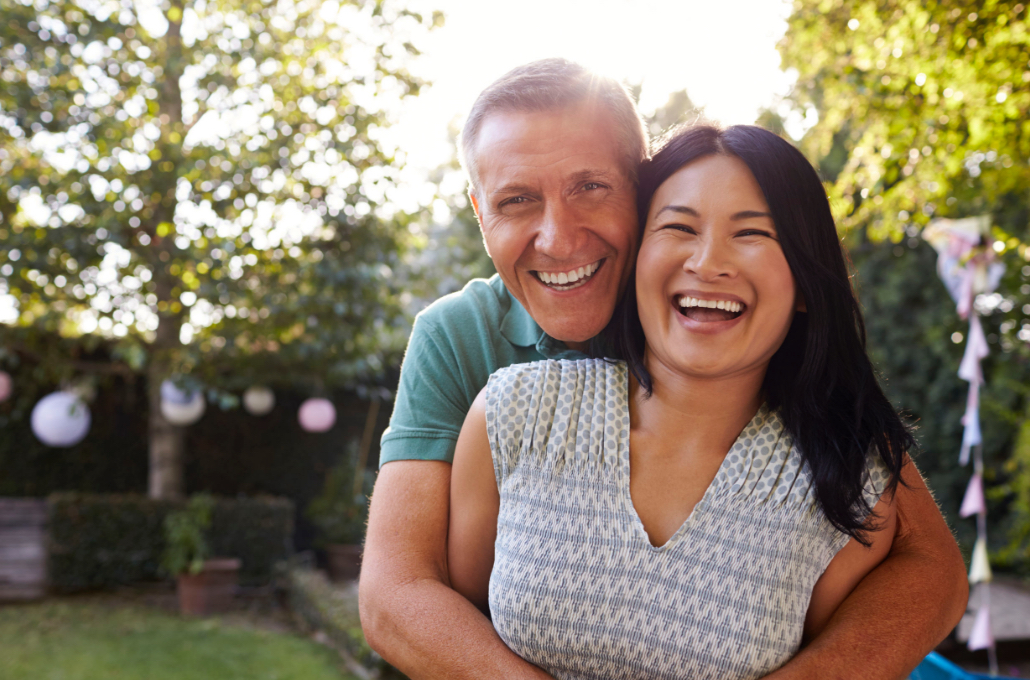 Leland Management Residents – Middle-Aged Couple Laughing and Hugging Outdoors